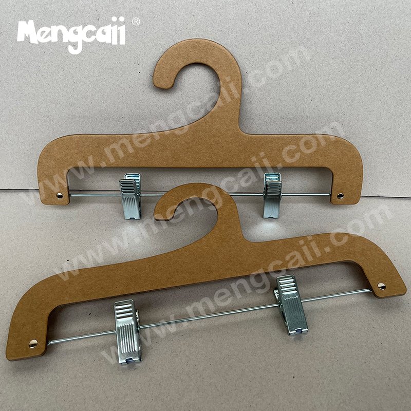 A custom-made clothing paper trouser clip for pants, consisting of a cardboard hanger and a hardware clip. The clip is removable and can display pants of different sizes. The hanger is recyclable, biodegradable, and eco-friendly.